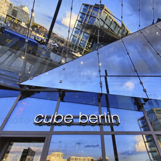 Cube Berlin, cube-shaped office building with inwardly folded glass façade reflecting the