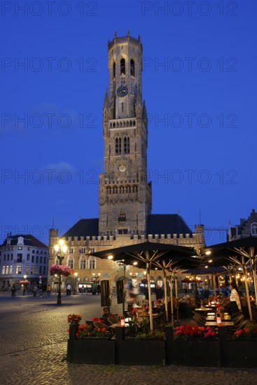 Illuminated Belfry in the historic city centre of Bruges in the evening light, Belfort and City