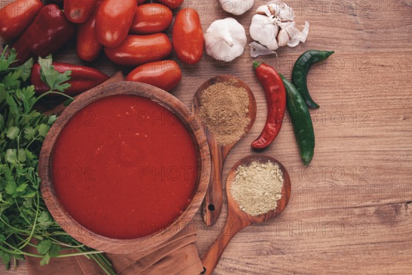 Georgian sauce, Satsebeli sauce, tomato and sweet pepper sauce, with spices, in a wooden bowl,