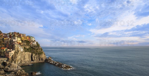 Manarola panorama with colorful buildings overlooking scenic shoreline. Cinque Terre landscapes in