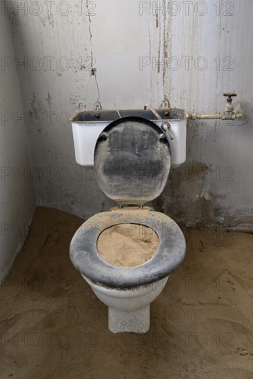 Toilet full of sand in the former hospital, Kolmanskop, restricted diamond area, Karas region,