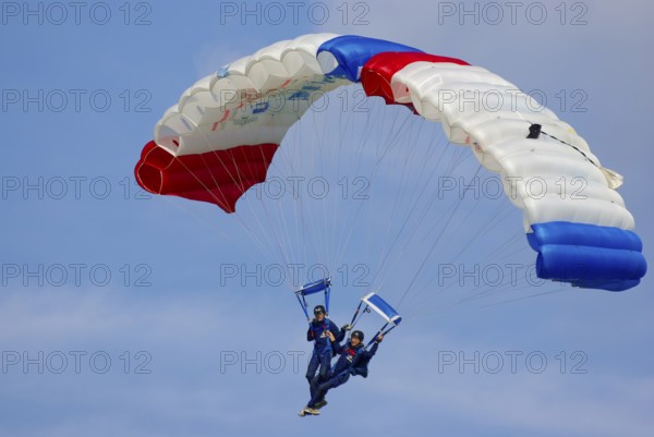 Two parachutists during an aerial acrobatic performance as part of an air show at the Rossfeld in