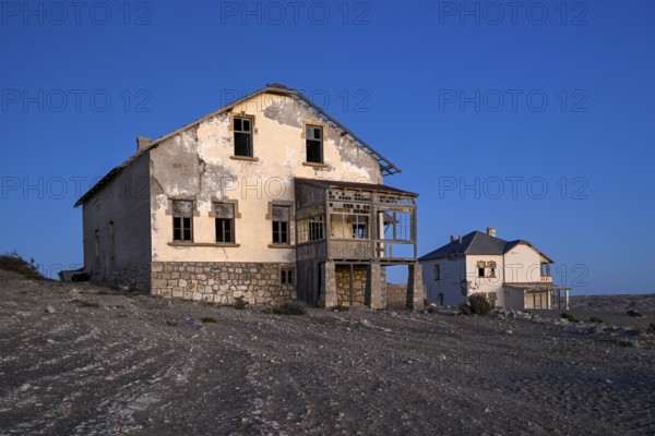 Dilapidated buildings in the desert sand, blue hour, Kolmanskop, near Lüderitz, Karas region,