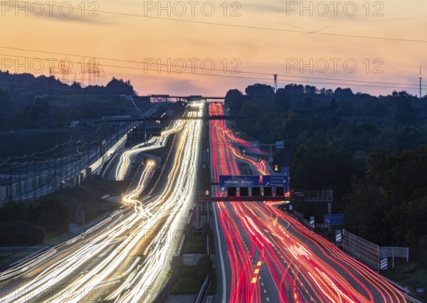 Motorway near Stuttgart with several lanes in the evening with sunset. Heavy traffic with light