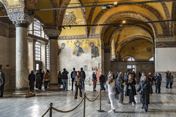 Visitors at the Deësis mosaic in the interior of today's Hagia Sophia mosque or Church of St