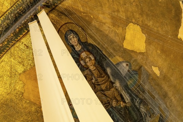 Mosaic with the Madonna and Child partially covered with fabric in the apse of the present-day