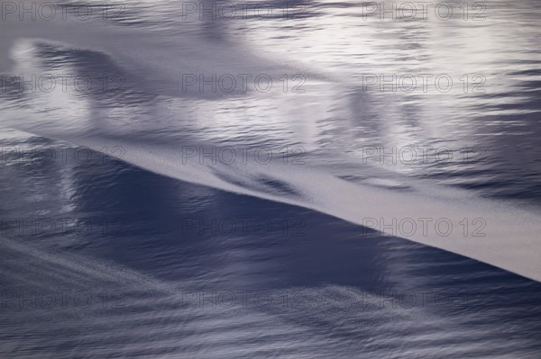 Light and shadow on gentle waves form structures on the sea surface in a bay, Otroya or Otrøya