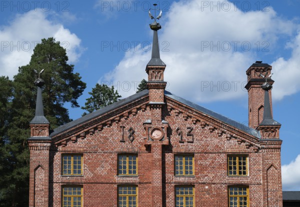 Multi-storey brick façade with inscription 1893, former paper factory and mill for the production