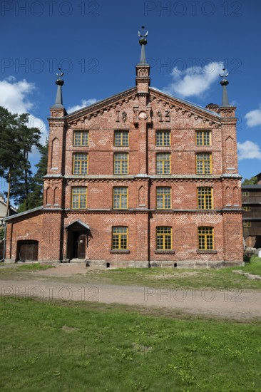 Multi-storey brick façade with inscription 1893, former paper factory and mill for the production