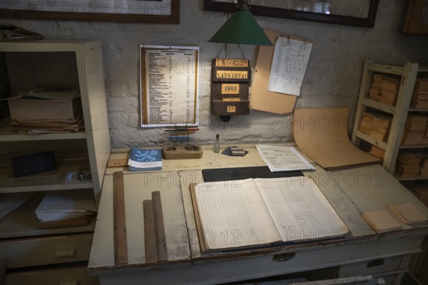 Desk in an office, former paper factory and mill for the production of groundwood pulp board,