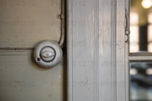 Old light switch on wooden wall, former paper factory and mill for the production of groundwood