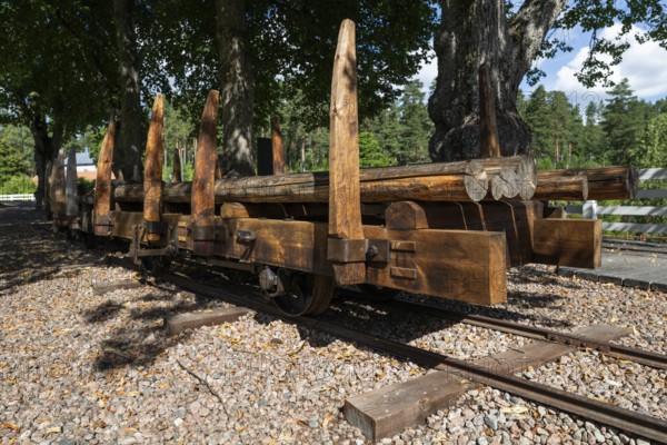 Railway tracks and wagons on rails for timber transport, former paper factory and mill for the