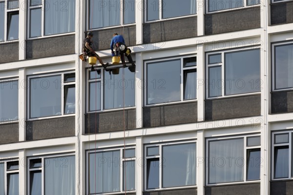Two male glass cleaners abseiling down the hotel façade to clean windows, aletto Hotel Kudamm,