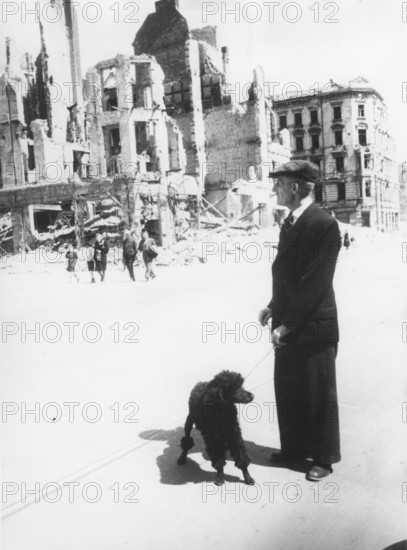Man with dog in destroyed Nuremberg, ruins, 1946