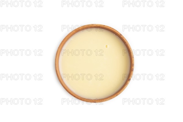 Organic non dairy banana and soy milk in clay cup isolated on white background. Vegan healthy food