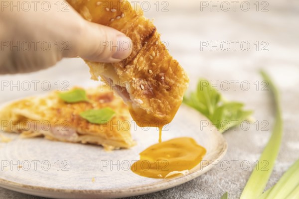 Fried homemade Khachapuri cake with hand with cheese and meat, fried in pan. Traditional Georgian