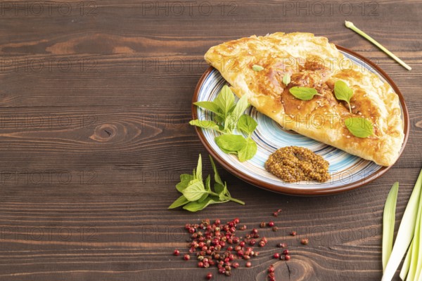 Fried homemade Khachapuri cake with cheese and meat, fried in pan. Traditional Georgian cuisine on