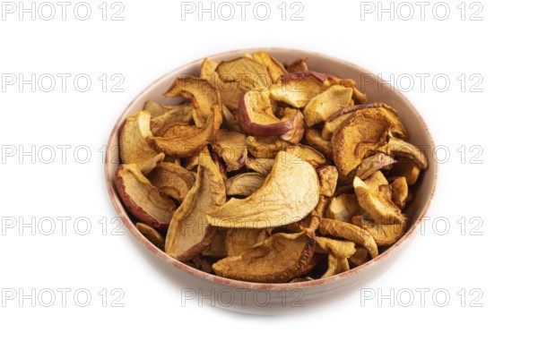 Dried Apples in ceramic bowl isolated on white background. Side view, close up. healthy food,