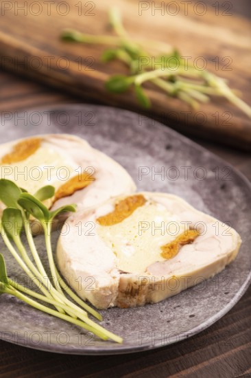 Chicken, egg and dried apricot meatloaf, microgreen on brown wooden. Diet, healthy eating. side