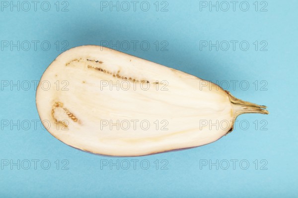Purple Cutted eggplant with white stripes on blue pastel background. Top view, flat lay, copy space