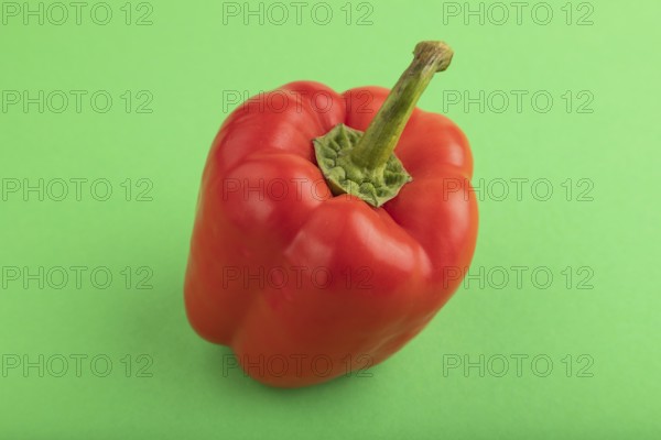 Red pepper on green pastel background. Side view, copy space. healthy food, vegetable, minimalism