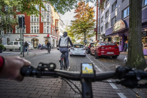 Cycling in the city, city centre road, cycle lane, two-wheeled traffic has priority, 30 km/h zone,