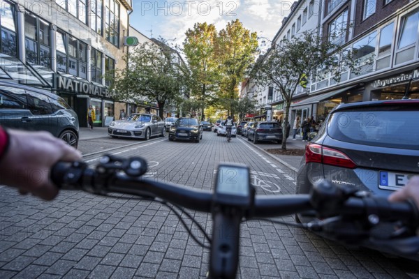 Cycling in the city, city centre road, cycle lane, two-wheeled traffic has priority, 30 km/h zone,