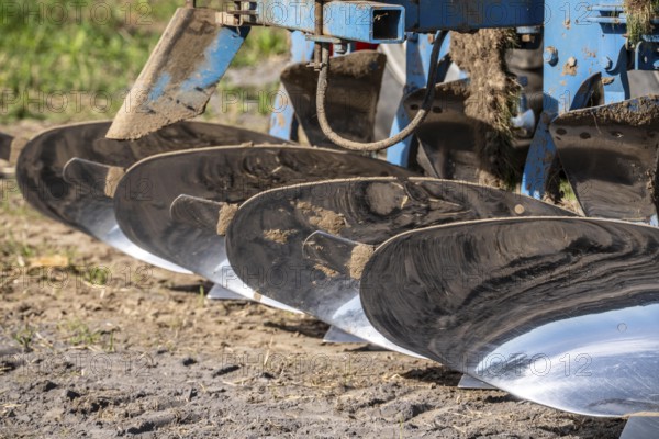 Plough, for ploughing a field, field, ploughshares, agricultural technology, shiny stainless steel,