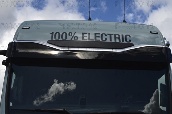 A sign on an electric lorry states that the vehicle is 100 percent electrically powered. The