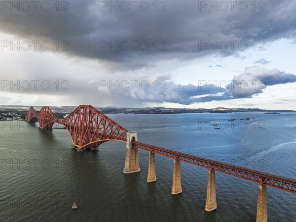 Rain clouds over Forth Bridge from a drone, Queensferry Crossing, Forth Estuary, Scotland, United