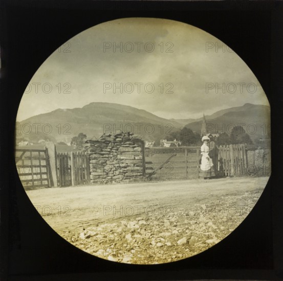Woman Victorian or Edwardian tourist with background of Ambleside, Lake District, Cumbria, England,