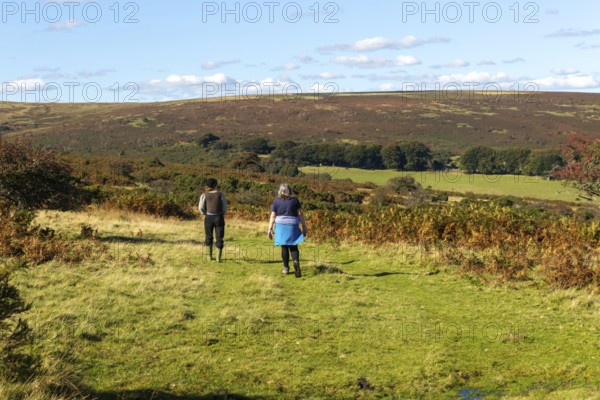Two women, mother and daughter, walking on moorland in autumn, near Hayford, Buckfastleigh,