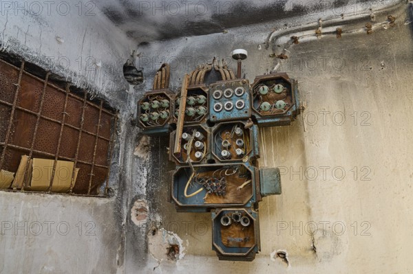 Lost Place, Rostige alte Elektrogeräte an einer verwitterten Wand im Gebäude, Caserma Avieri,