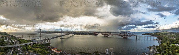 Sunset Panorama of Rain clouds over Forth Bridge from a drone, Queensferry Crossing, Forth Estuary,