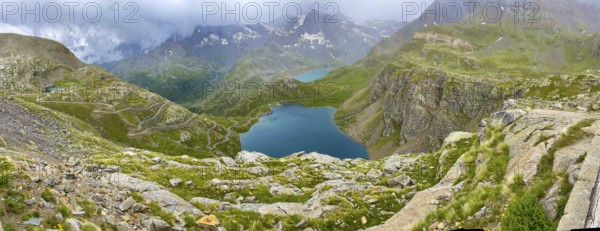 Panoramic view of left serpentine narrow bends from ascent pass road to Alpine pass Colle del Col