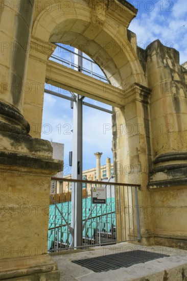 View through former arched window of ruins of former opera house Royal Opera House of Valletta
