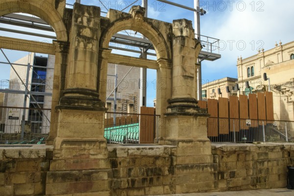 View through former arched window of ruins of former opera house Royal Opera House of Valletta
