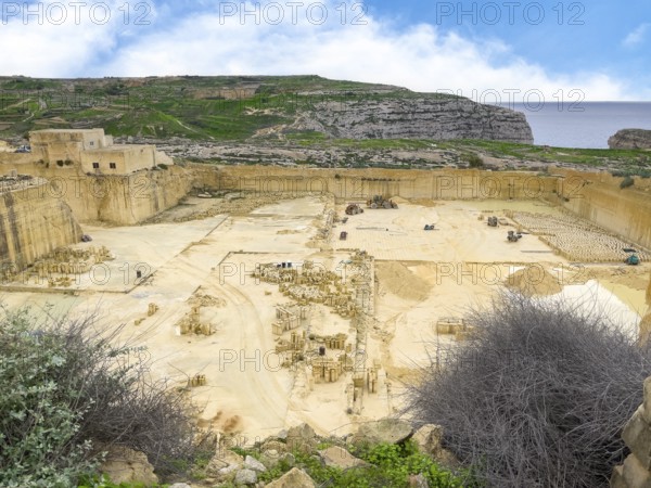 View from above into sandstone sand-lime brick quarry, in the background vertically cut quarried