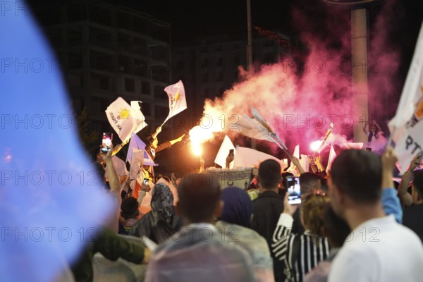 Gaziantep, Türkiye – May 28, 2023. Turkish citizens wave flags of Türkiye and the ruling Justice