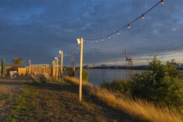 View from the outside area of a restaurant at Lankenauer Höft through a string of lights onto