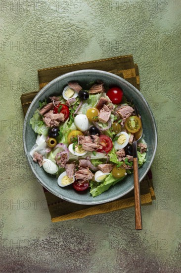 Salad with canned tuna, vegetable salad with quail eggs, lettuce, red onion, cherry tomatoes,