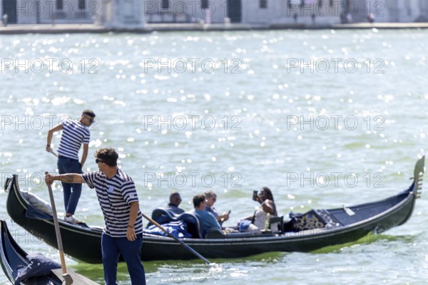 Venice, Italy - 3 September 2025: Gondolier on a gondola in Venice during the 82nd Venice