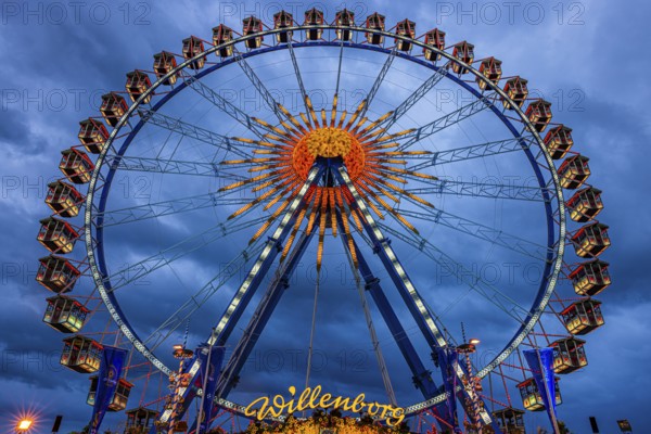 Dark clouds behind the illuminated Ferris wheel, Festwiese, Theresienwiese, Oktoberfest, Munich,