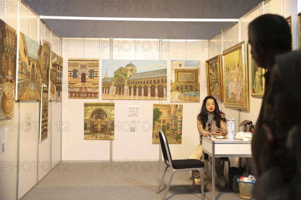 Syrian artisans display handmade artistic pieces to visitors at the Damascus International Fair.