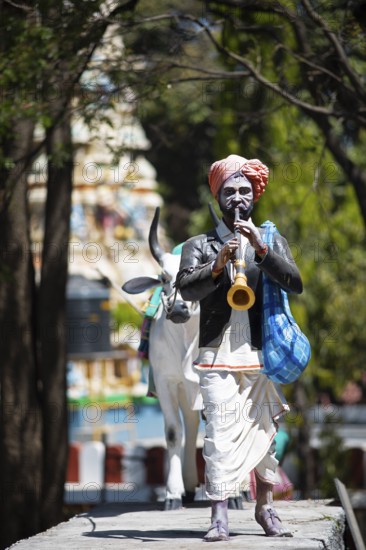 Statue of a farmer playing the shenai or traditional flute at the Hindu Basavanagudi Bull Temple,