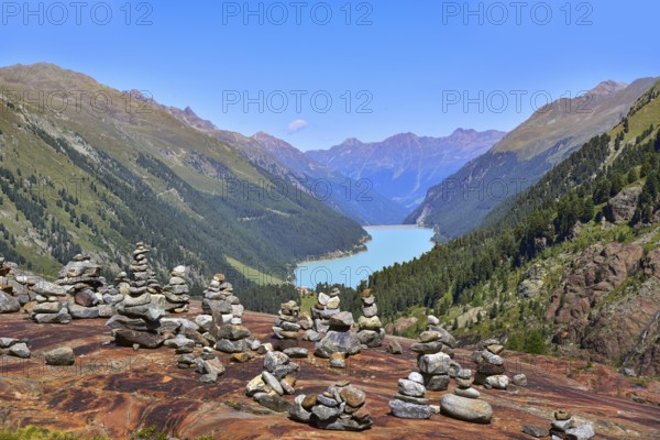 Hiking area below the Gepatsch Glacier in the Kaunertal with red rocks and the Kaunertal reservoir