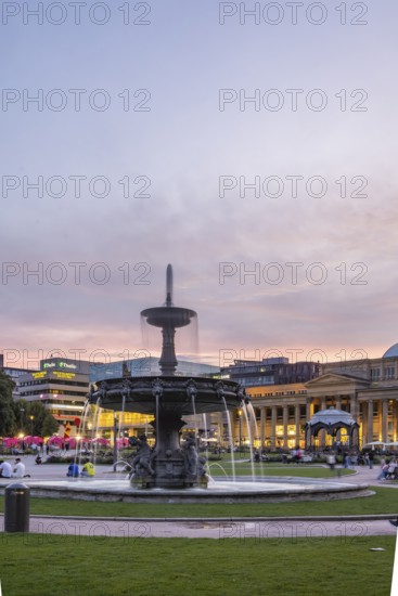 Evening atmosphere at Schlossplatz Stuttgart. View of Königstraße, art museum and Königsbau.