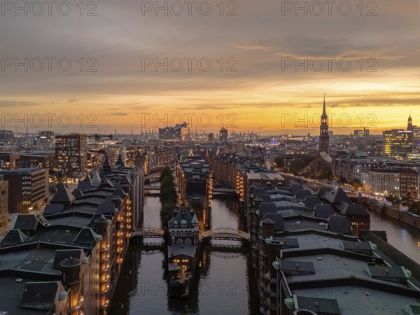 Aerial view of the Speicherstadt Hamburg with evening lighting and view over the harbour with
