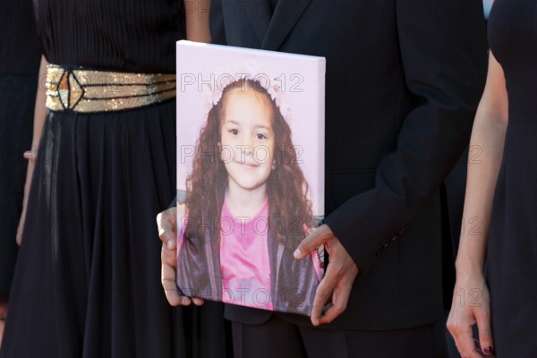 Venice, Italy - 3 September 2025: Motaz Malhees with a portrait of five-year-old Palestinian girl