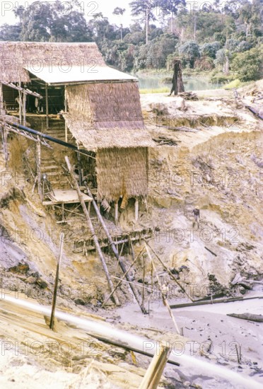 Open Cast gravel-pumping tin mine Malaya, Malaysia, south east Asia 1964 - pumping raises the